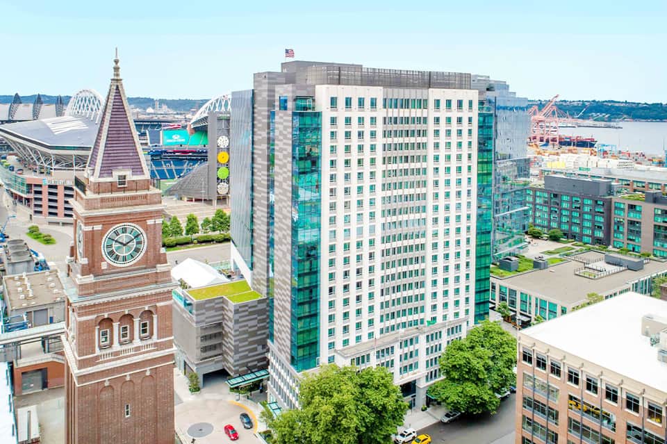Downtown waterfront hotel building with clock tower visible and water views in background