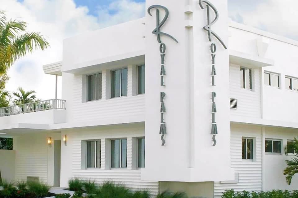 Modern white multi-story building with 'Royal Palais' signage and contemporary architectural design