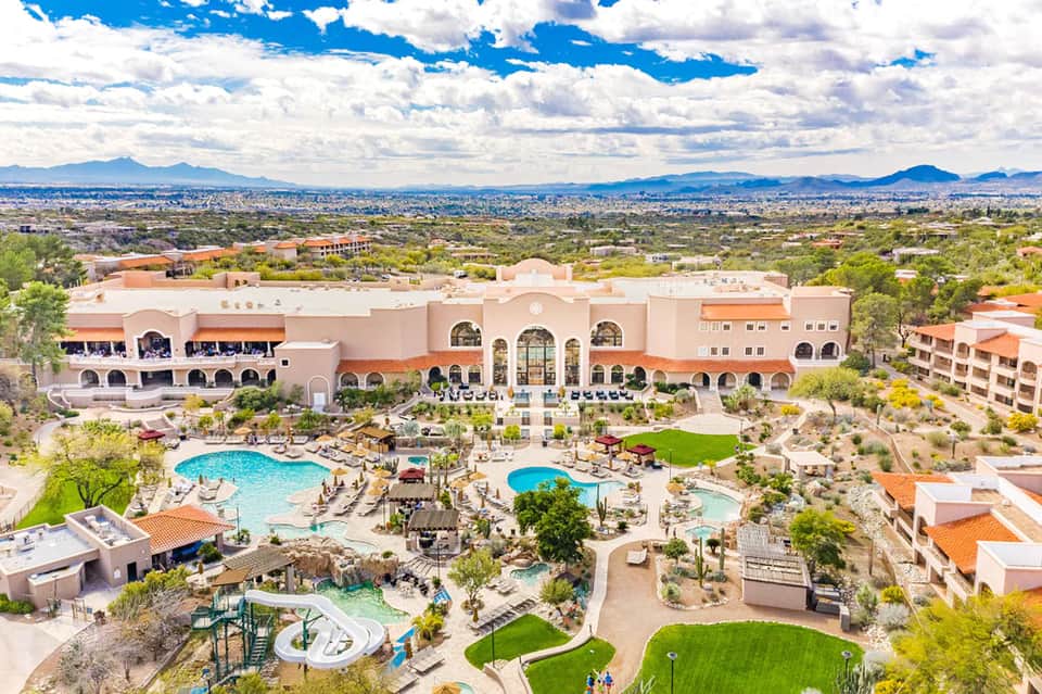 Aerial view of large resort with multiple pools, spa, and desert landscape