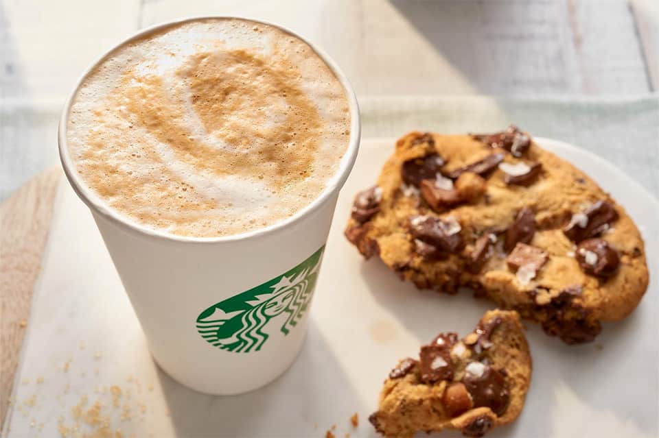 Starbucks coffee drink and chocolate chip cookies on white surface