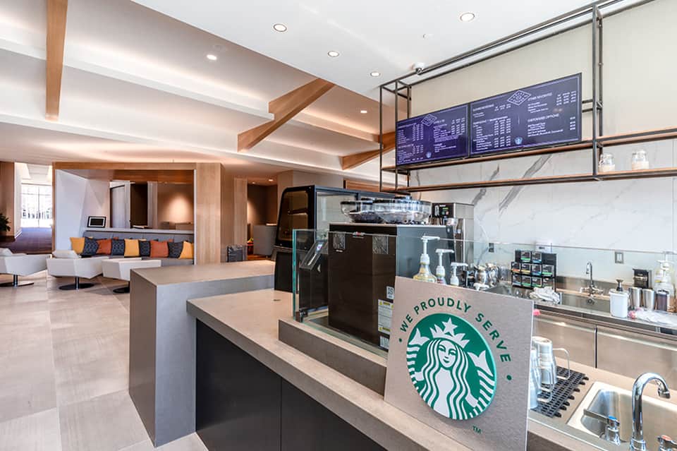 Contemporary Starbucks coffee shop interior with wooden beams and modern seating area