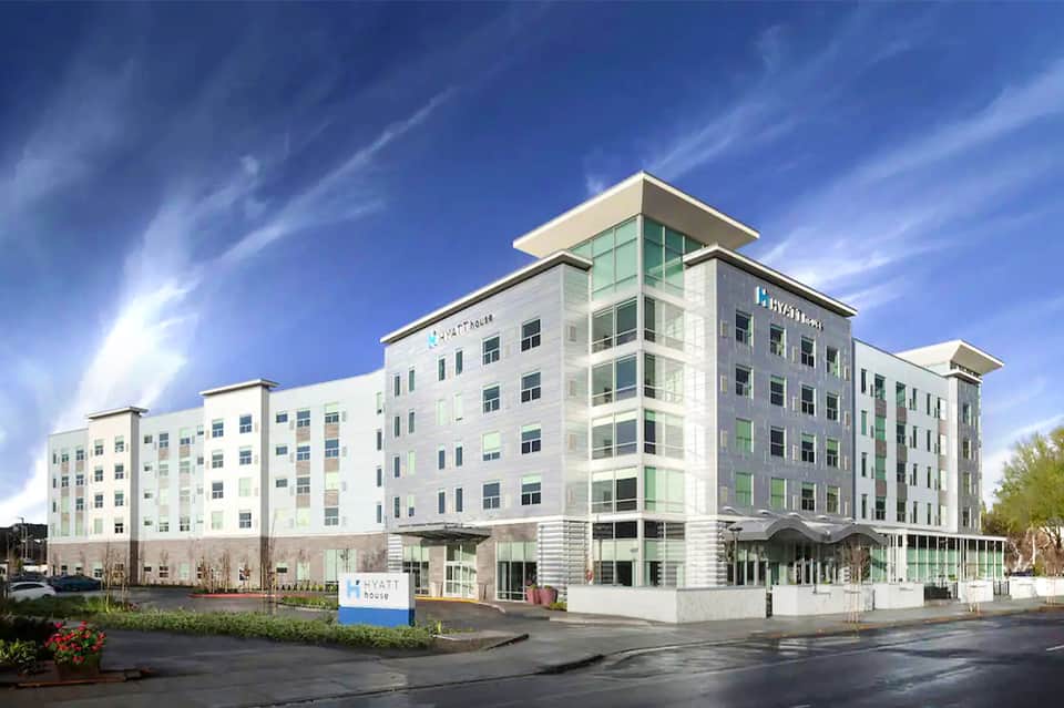 Contemporary Hyatt hotel exterior with white facade and green glass accents