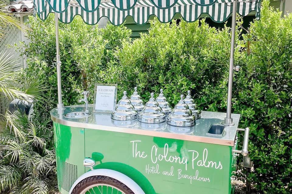 Green ice cream cart with striped awning at The Colony Palms Hotel and Bungalows
