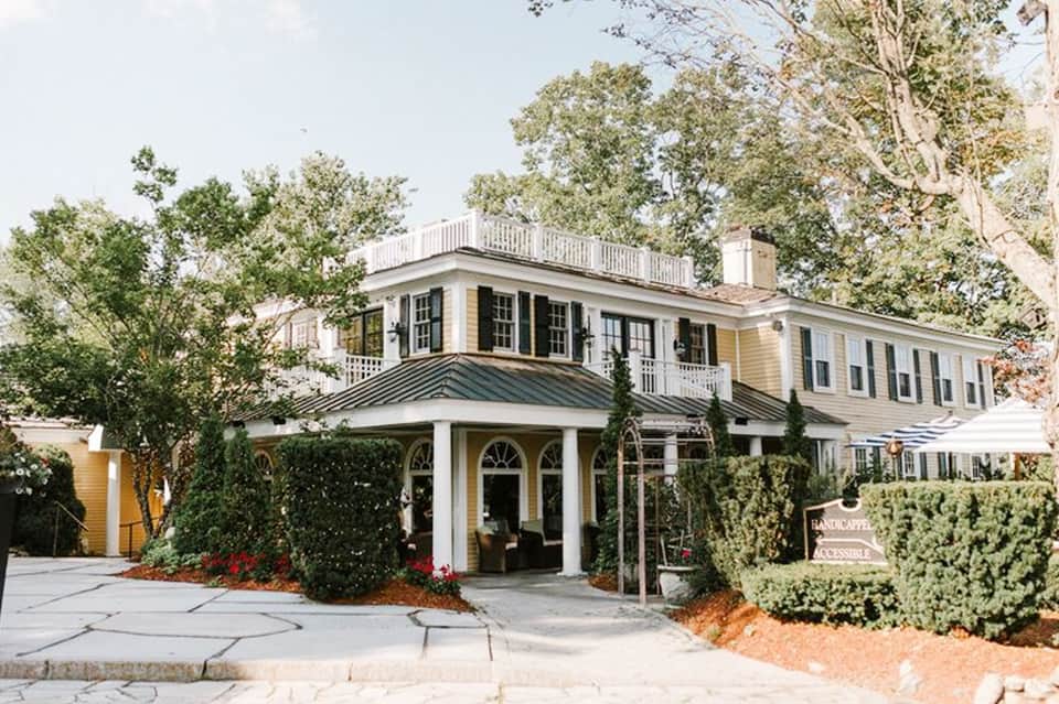 Colonial-style beachfront house with white columns and wraparound porch