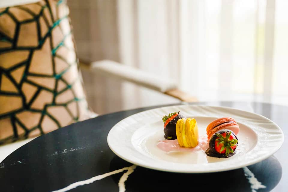 Fine dining plate featuring artfully arranged stuffed peppers and seared protein with elegant plating
