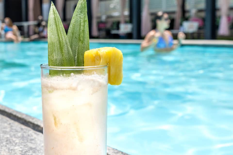 Refreshing cocktail with lime garnish by pool at resort
