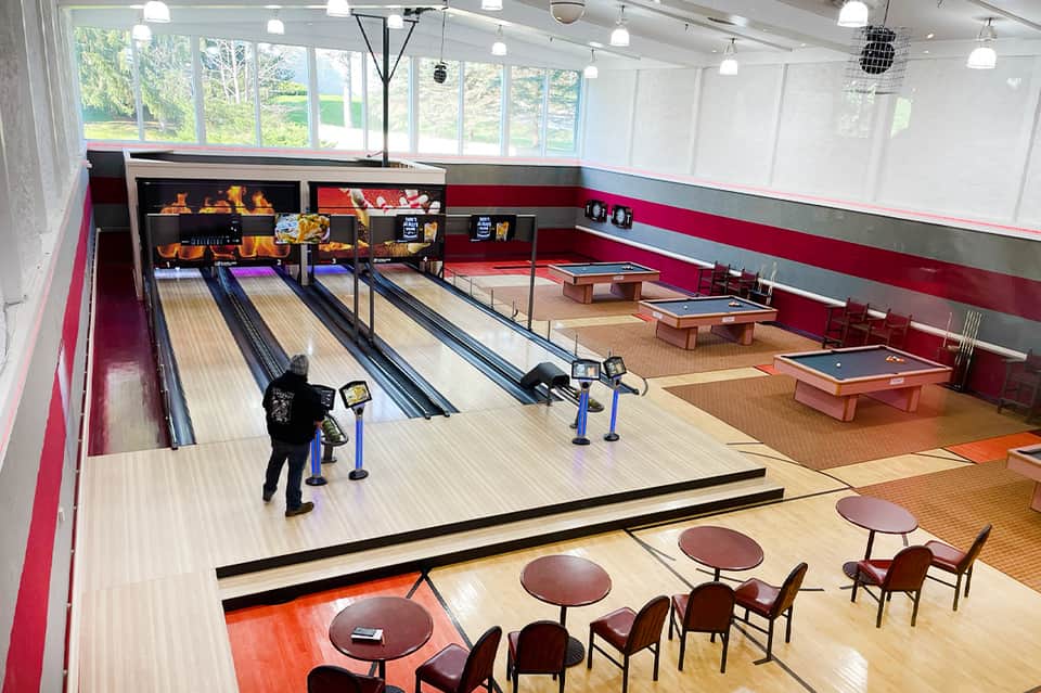 Indoor recreation center with bowling lanes, pool tables, and ping pong tables