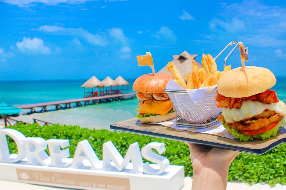 Gourmet burgers and fries served on boardwalk overlooking tropical ocean resort