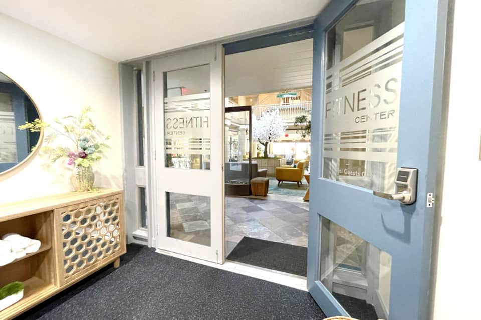 Fitness center entrance with glass doors and modern architectural design