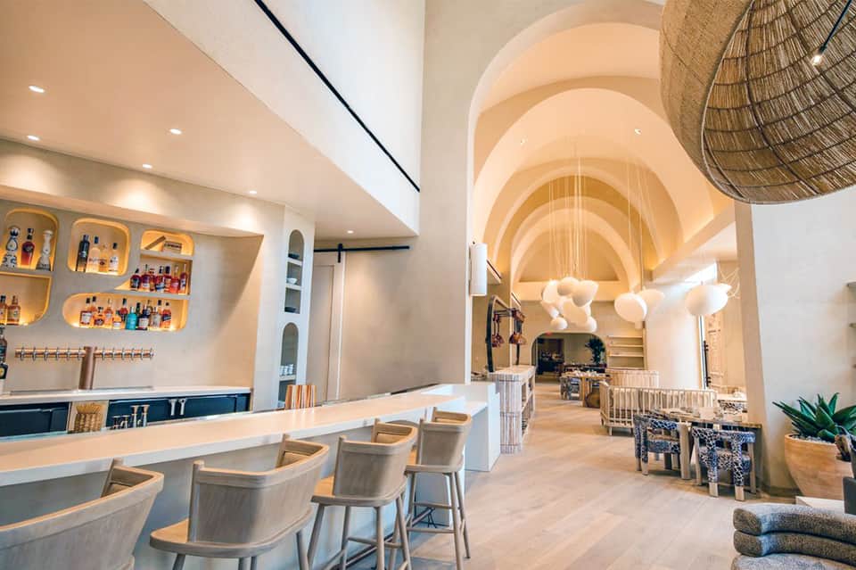 Modern hotel spa and bar interior with curved architecture, wooden finishes, and contemporary design