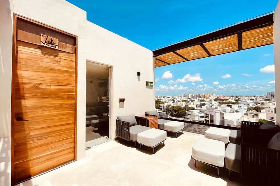 Modern rooftop terrace with lounge chairs and panoramic city skyline views
