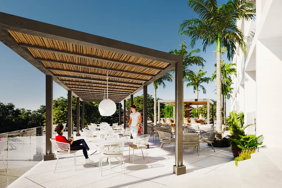 Shaded pergola patio with modern seating and tropical landscaping at resort