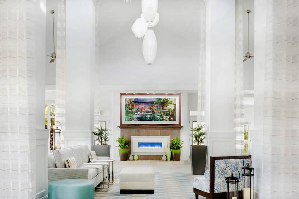 Spa relaxation area with fireplace, modern furnishings, soft lighting, and transitional design elements