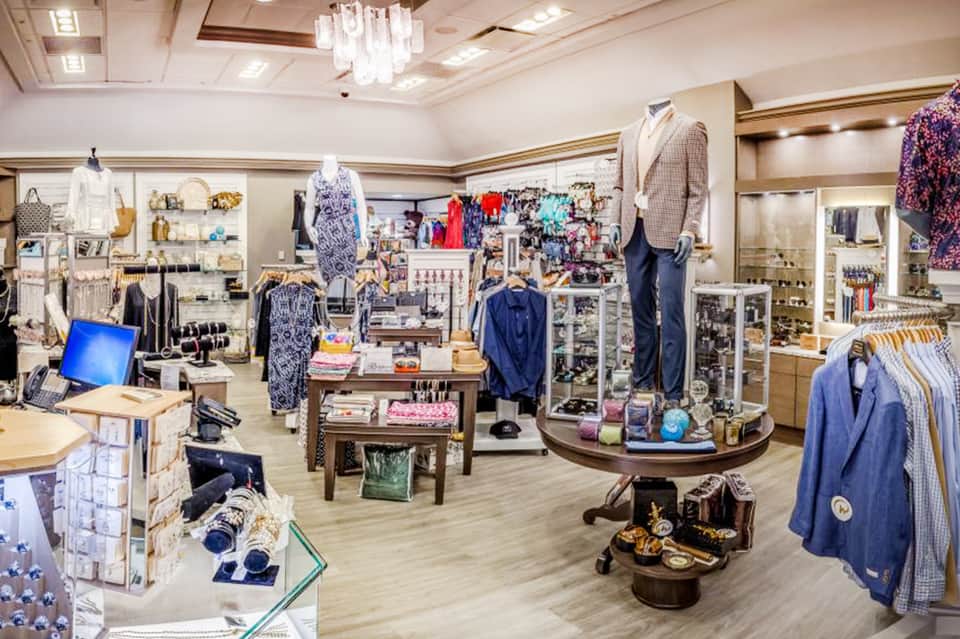 Upscale boutique interior with clothing displays, accessories, and modern retail fixtures