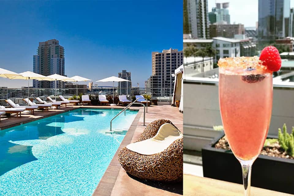 Rooftop pool with city skyline views and a coral cocktail with raspberry garnish