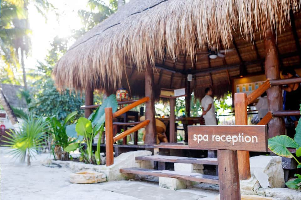 Tropical spa reception building with thatched roof and wooden architecture