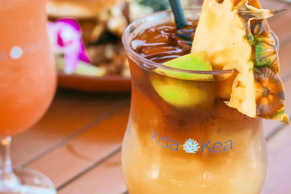 Tropical cocktail with pineapple garnish at a beachside resort bar