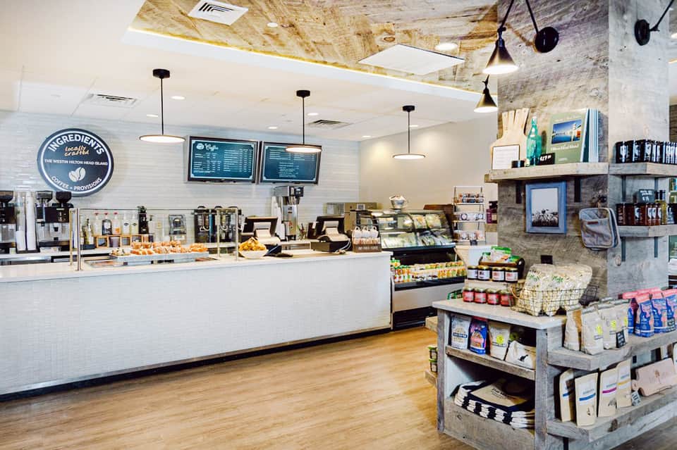 Modern café interior with white brick walls, menu boards, and casual seating area