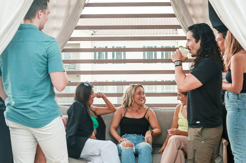 Group of people socializing on modern stairs with ocean views in background
