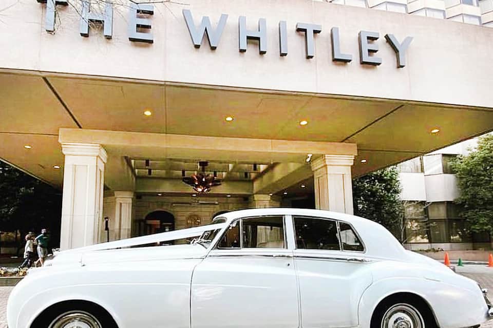 Vintage white Rolls Royce parked under The Whitley hotel entrance awning