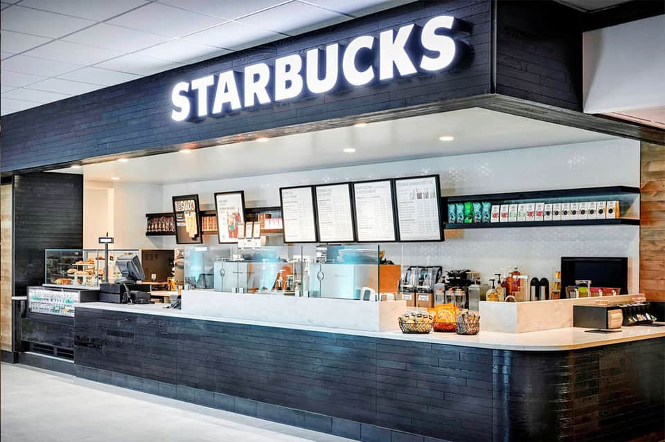 Starbucks coffee shop with dark wood counter and menu boards