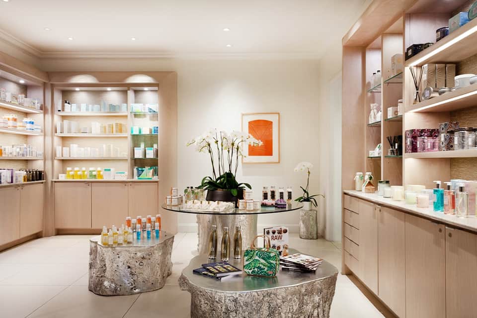 Luxury spa retail interior with wooden shelving displaying skincare products