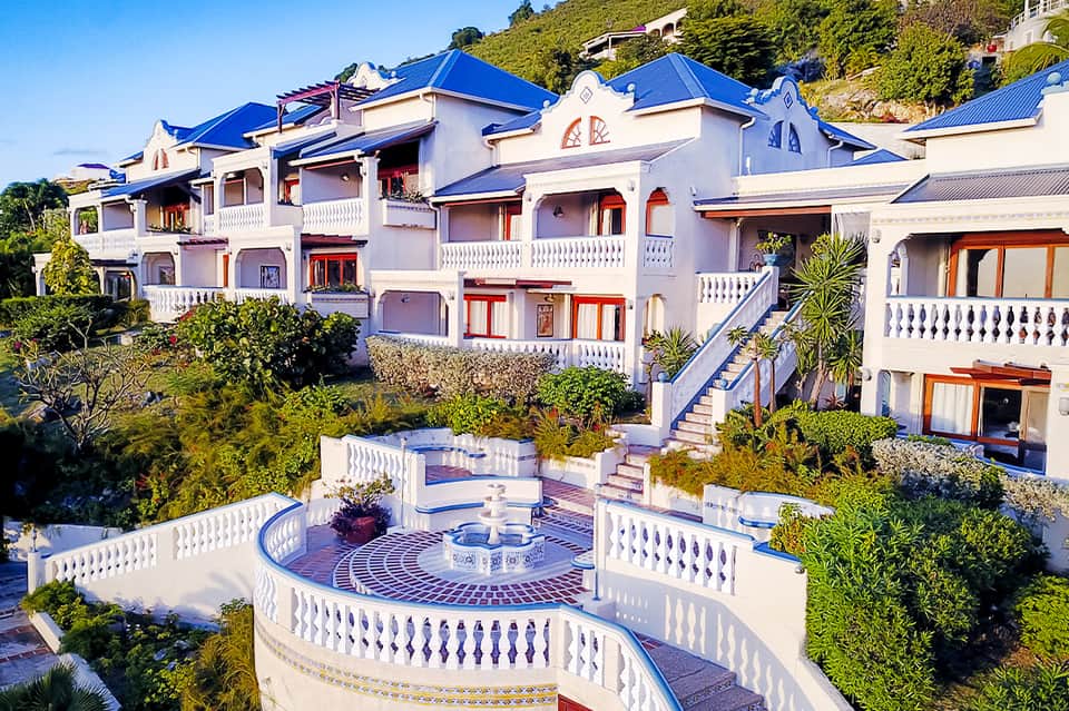Colorful Mediterranean-style resort buildings with blue roofs and white railings