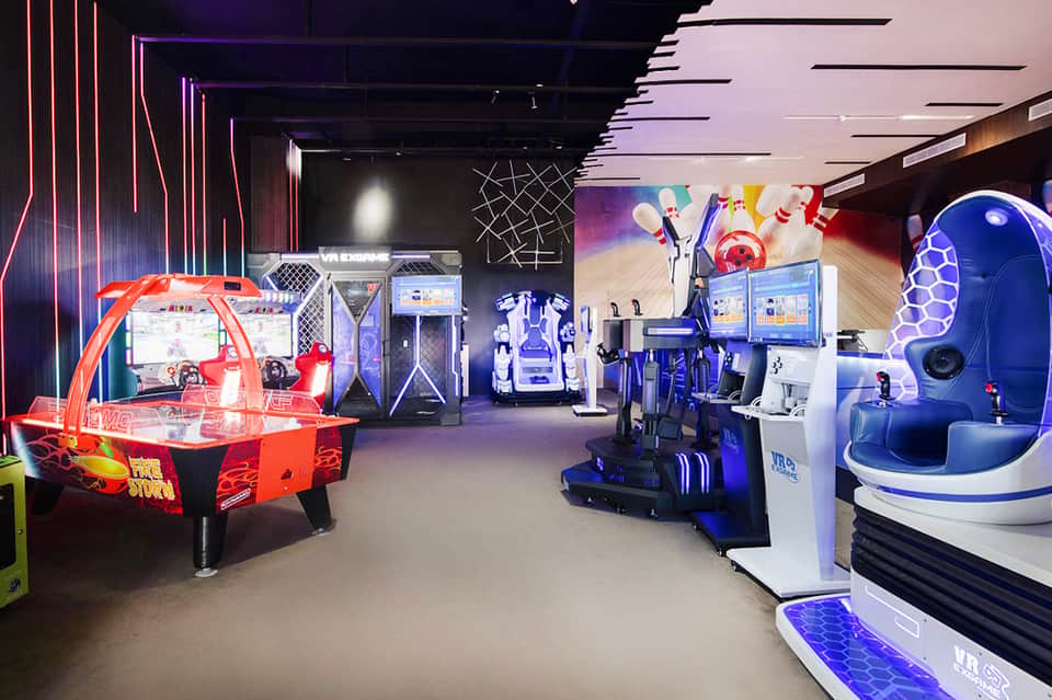 Arcade and entertainment center with neon signs and interactive gaming machines