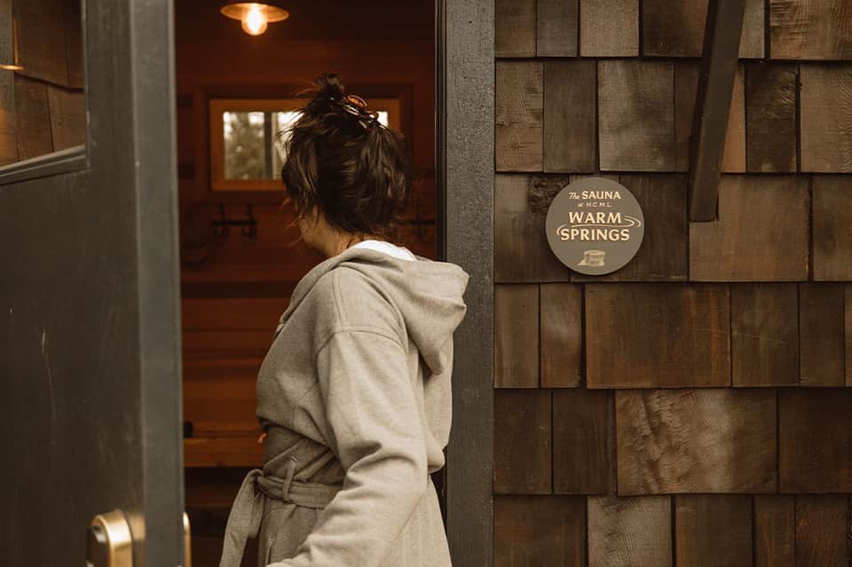 Guest entering warm springs sauna facility at hotel spa