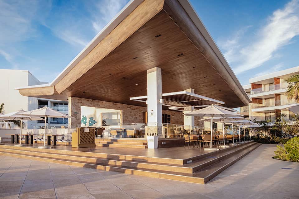 Contemporary beachfront restaurant pavilion with wooden architecture and ocean views