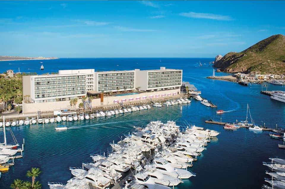 Mediterranean coastal resort with marina, boats, and blue water views
