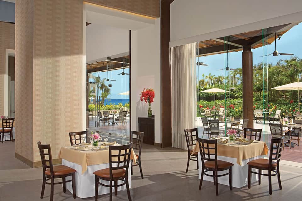 Fine dining restaurant with ocean views, tropical garden, and covered patio area