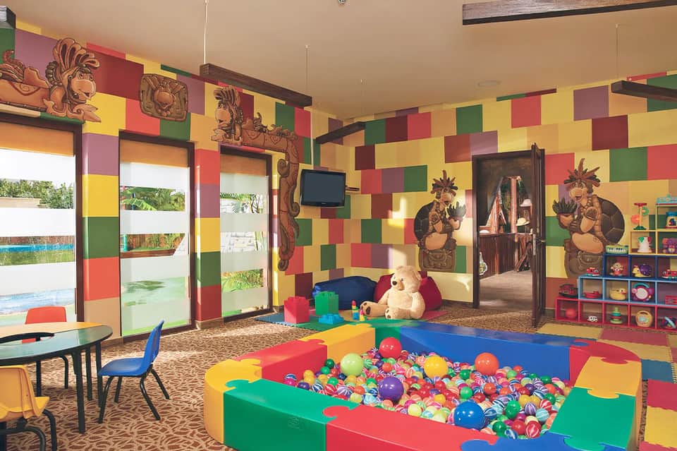 Colorful kids play room with ball pit and activity stations