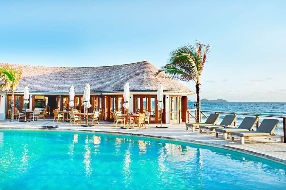 Luxury beachfront resort with pool, cabanas, and ocean view