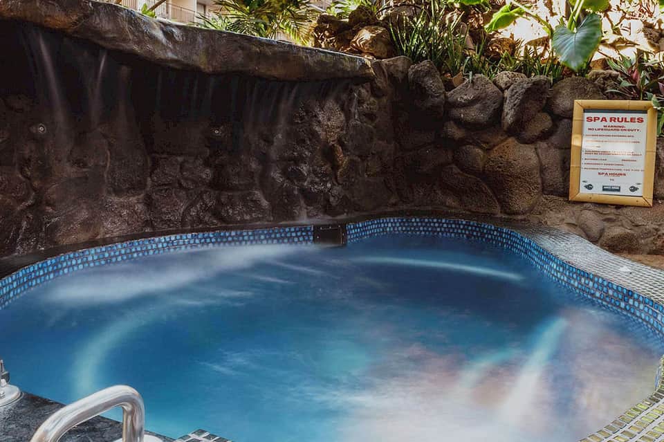 Natural hot spring spa pool with steaming water and stone surroundings