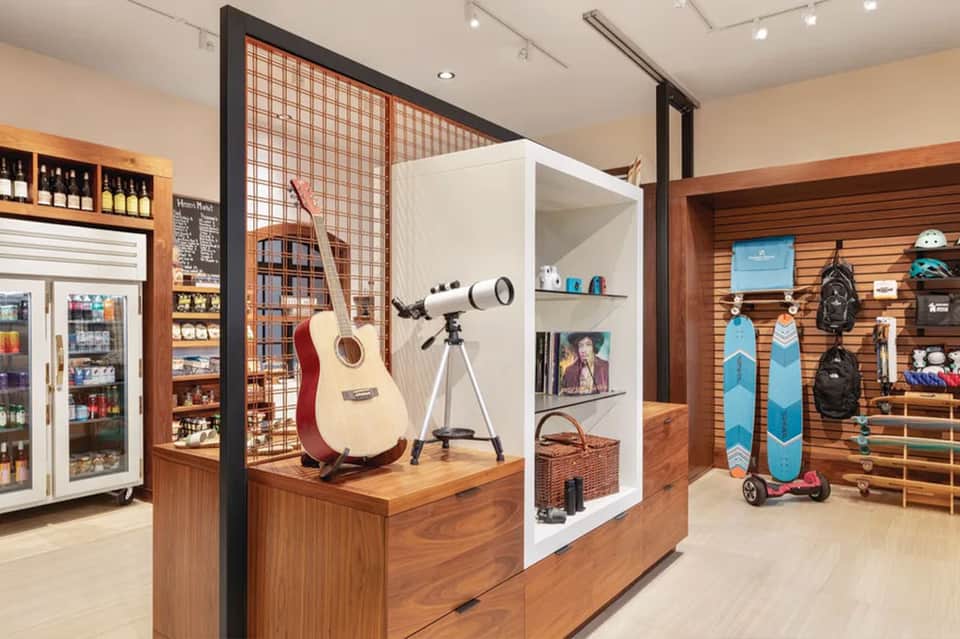 Retail shop interior with guitar display, sports equipment, and beverage cooler