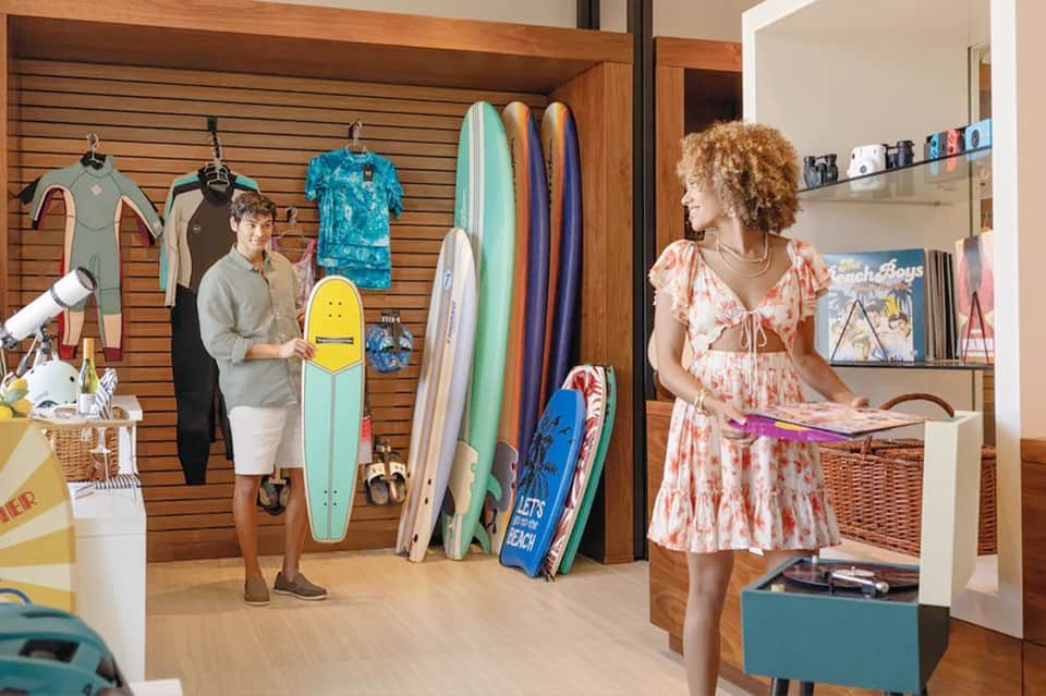 Retail shop interior with wetsuits, surfboards, and beach apparel displayed