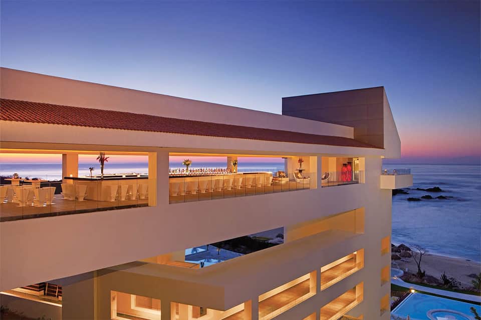 Oceanfront restaurant terrace with ocean views at dusk and modern architectural design