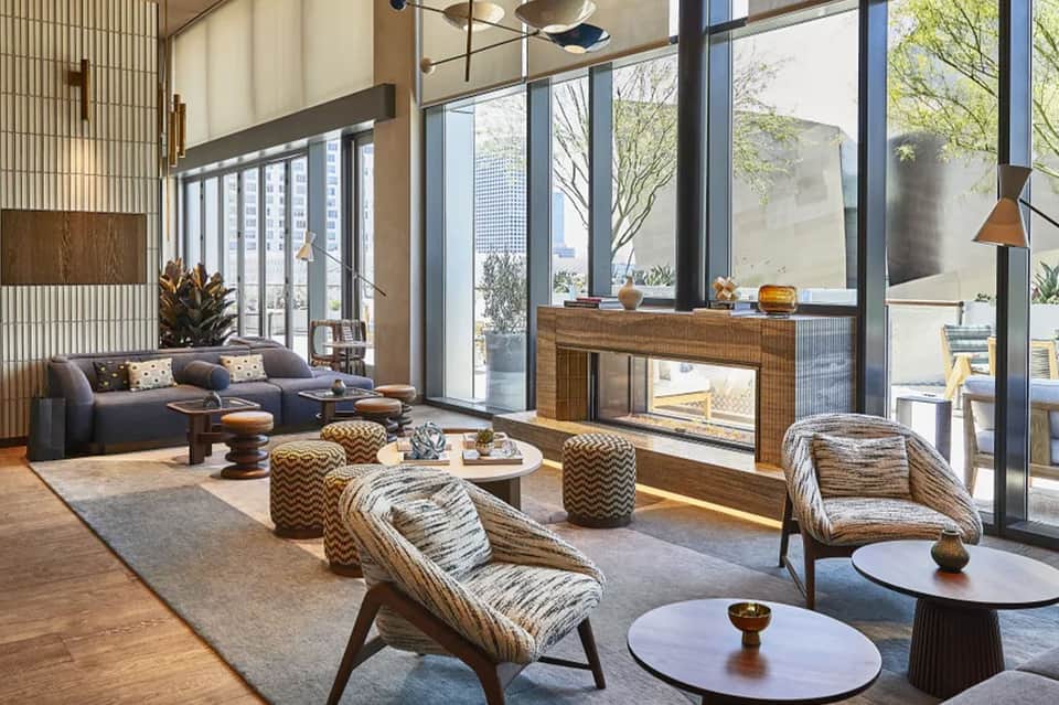 Contemporary penthouse lounge with floor-to-ceiling windows and city skyline views