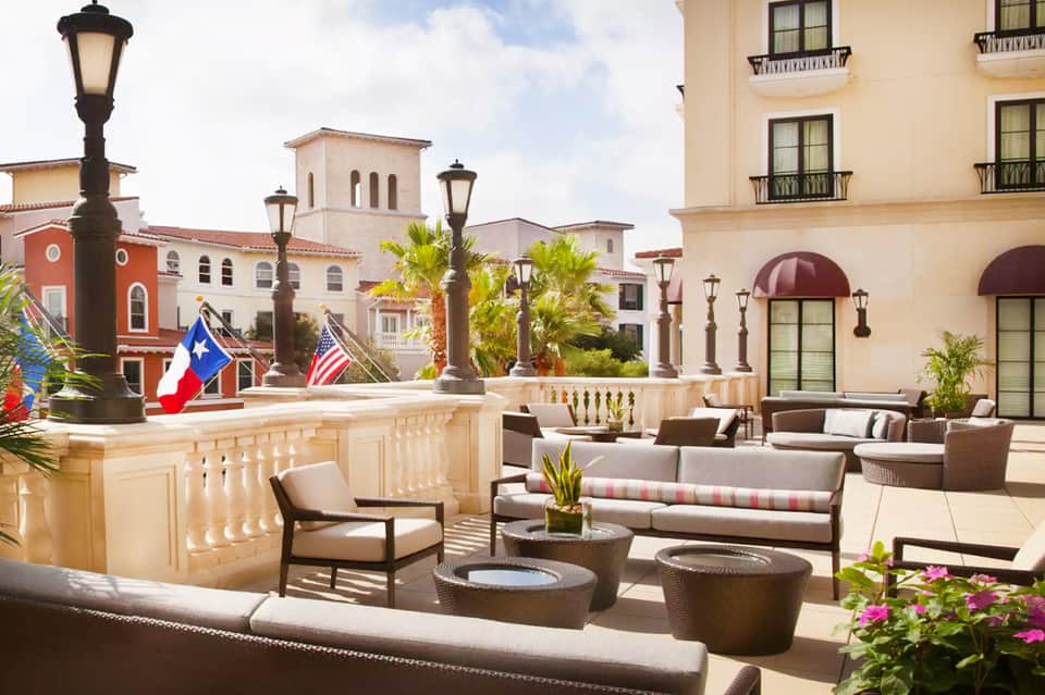 Upscale resort terrace with Spanish colonial architecture and ocean views