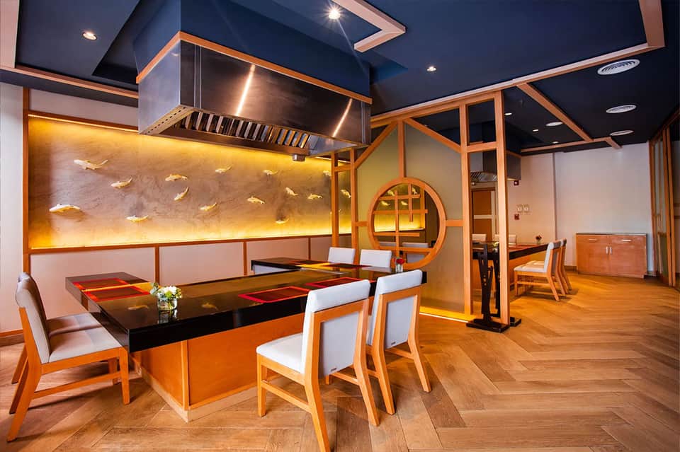 Modern Japanese-inspired dining room with black ceiling and wooden accents