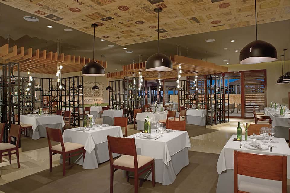 Fine dining restaurant with white tablecloths, wooden chairs, and decorative screens