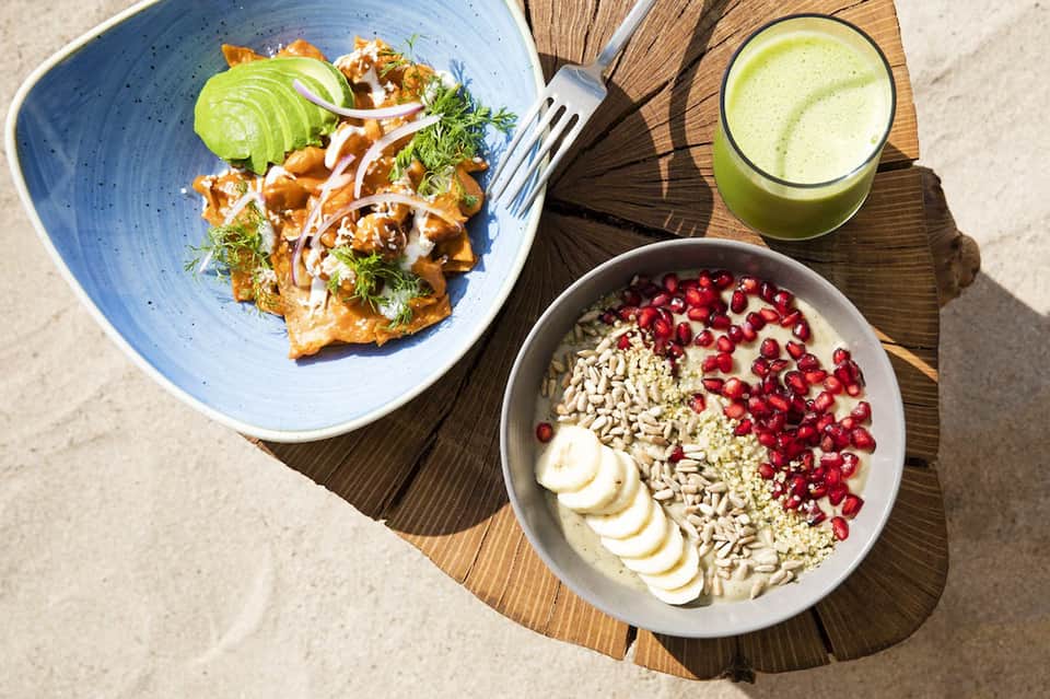 Healthy meal spread with fresh salad, smoothie, and yogurt bowl with berries