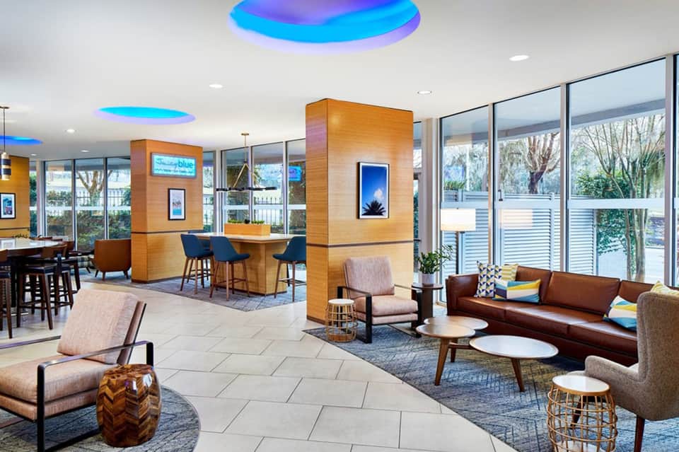 Modern hotel lobby with colorful ceiling lights and contemporary furnishings
