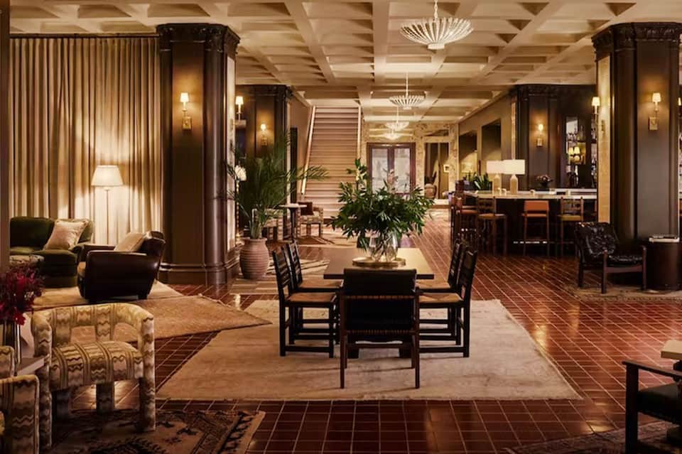 Elegant hotel lobby with dark columns, warm lighting, and refined furnishings