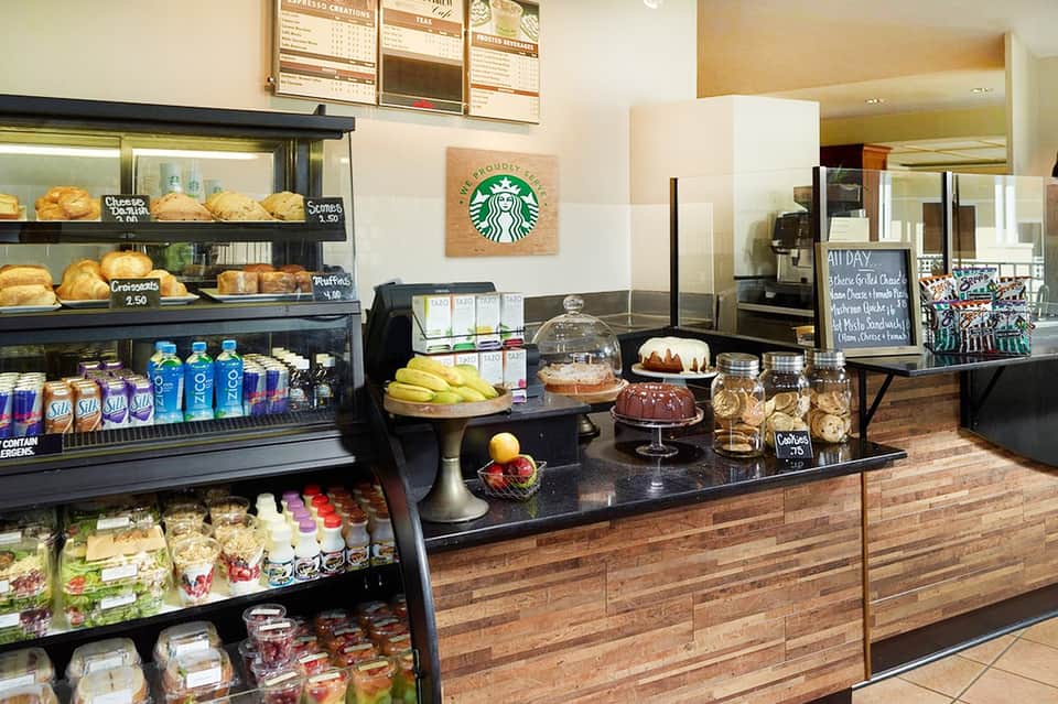 Starbucks location with pastry display case and café seating area