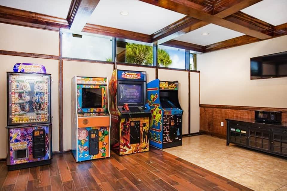 Game room with vintage arcade machines and colorful cabinets in modern hotel space