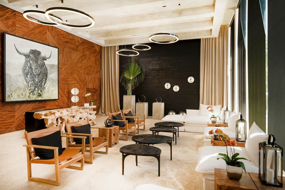 Contemporary spa or wellness lounge with wooden walls, black furnishings, and modern decor