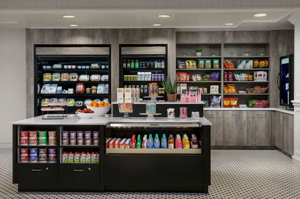 Modern convenience store interior with refrigerated displays, snacks, and organized shelving