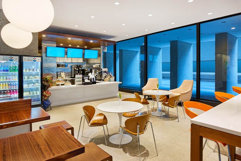 Modern resort cafe with ocean views, serving counter, and seating area